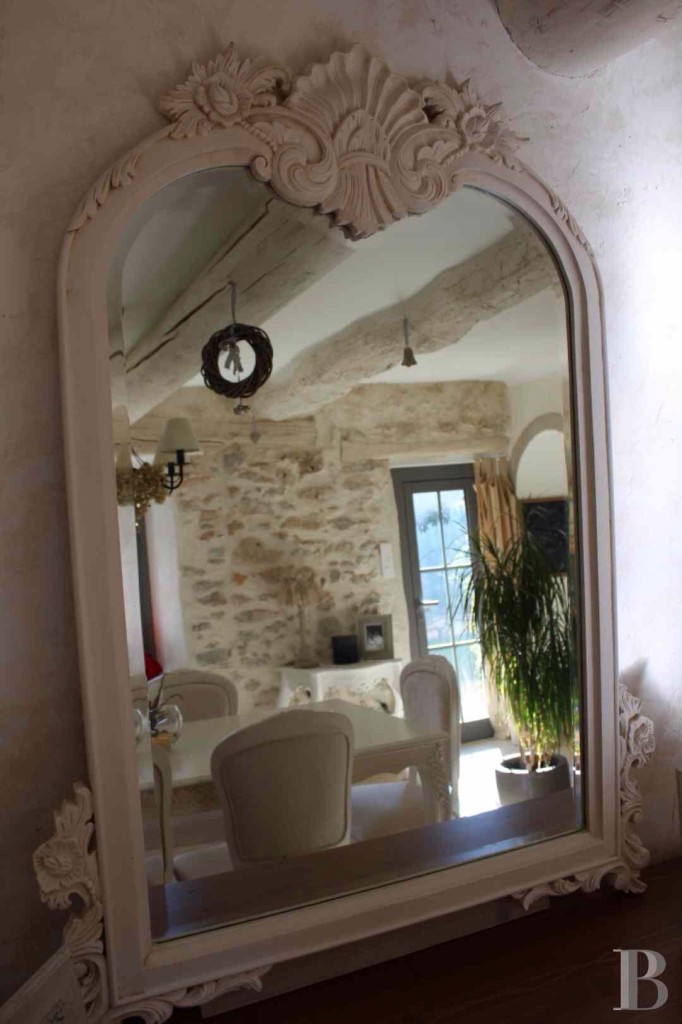 "Dreamy Chic Mirror That Is Showing Off The Beautiful Creamy Stone In This Country French Dining Space"